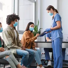 A patient signing papers with a doctor